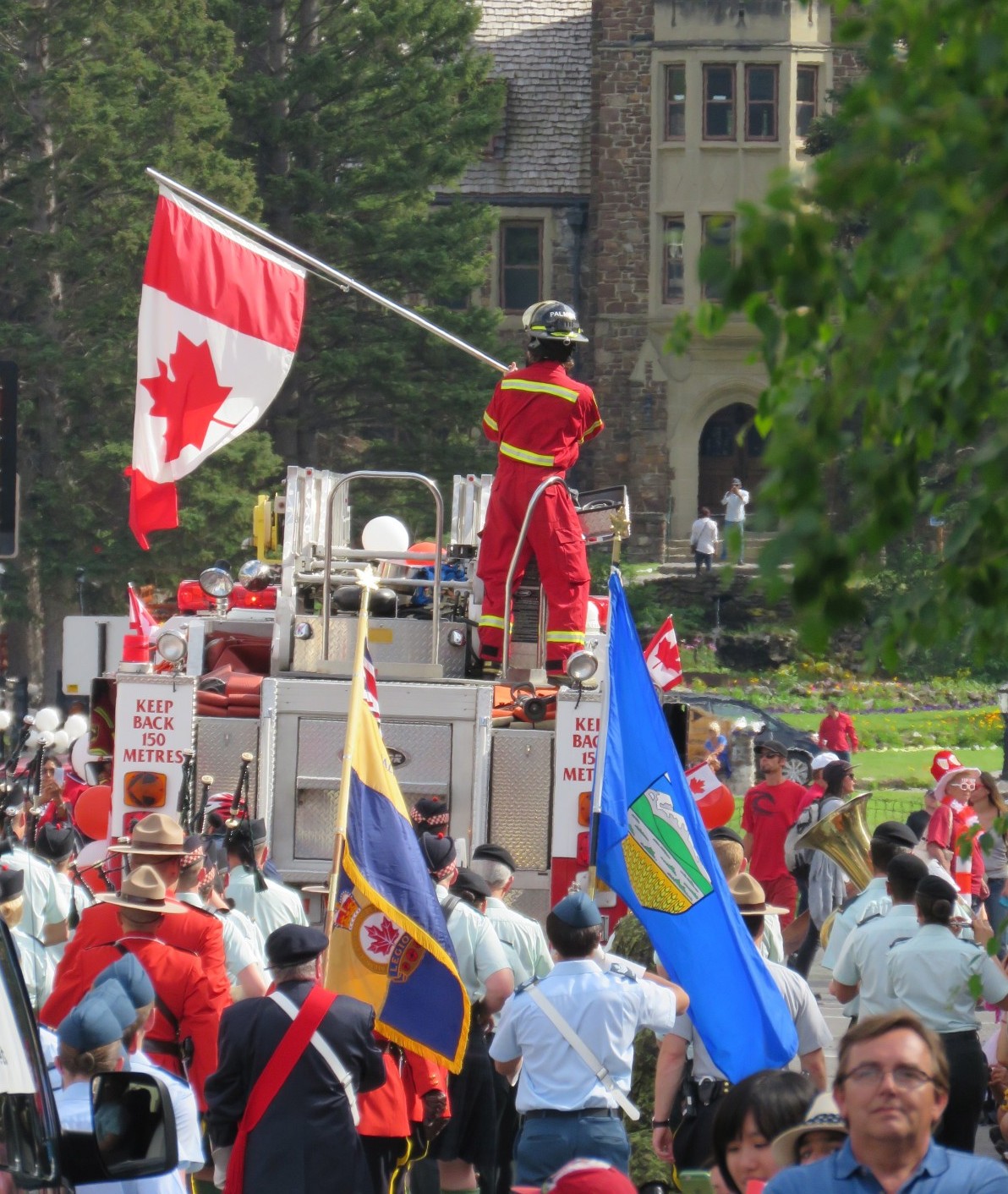 Canadian firefighter waving the Canadian flag, Canada Day, Banff, Canada